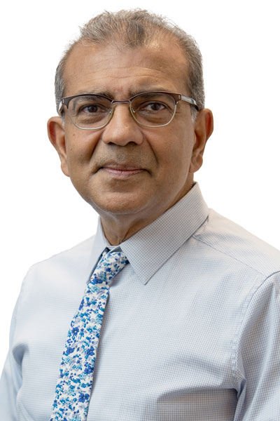 princeton radiology doctor with a soft smile, white button down shirt and blue and white floral tie