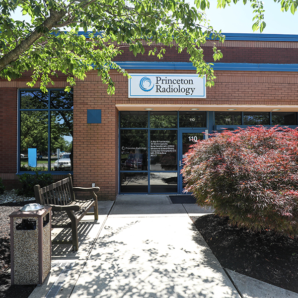 princeton radiology office entrance in a brick building with trees, bench, and landscaped walkway